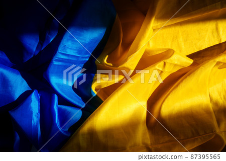 Yellow-blue fabric. The state flag of Ukraine. Hard shadows in the photo 87395565