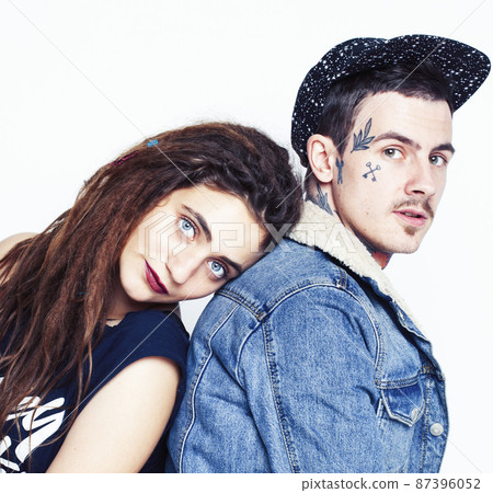 Young couple together. guy with tattoo, girlfriend wearing dreadlocks having fun on white background Young couple together. guy with tattoo, girlfriend wearing dreadlocks having fun on white background 87396052
