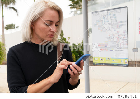 Girl at bus stop 87396411