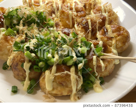 Takoyaki topped with green onions 87396438