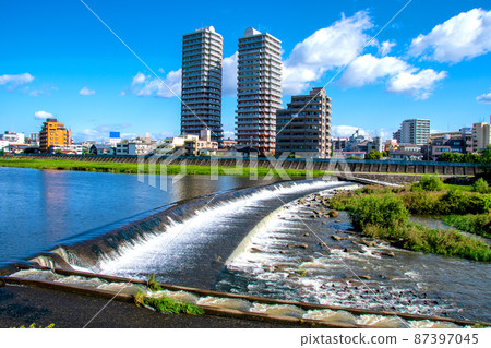 View of the left bank from the right bank promenade of the City of Trees Sendai, early autumn, Hirose River, Koriyama dam View of the left bank from the right bank promenade of the City of Trees Sendai, early autumn, Hirose River, Koriyama dam 87397045