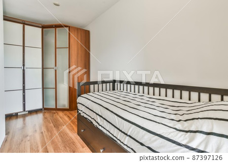 Compact room for one person with a comfortable bed and soft linens Compact room for one person with a comfortable bed and soft linens 87397126