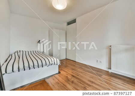 Compact room for one person with a comfortable bed and soft linens Compact room for one person with a comfortable bed and soft linens 87397127