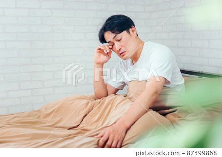 A man in the bedroom (gets up) A man in the bedroom (gets up) 87399868