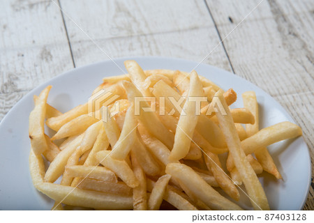 French Fries Asian street food in a white plate on the wooden floor French Fries, BBQ Sauce, Tomato Soy Sauce 87403128