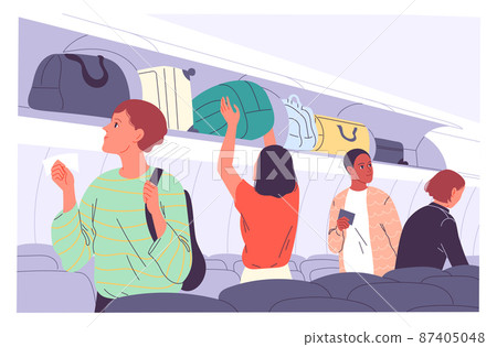 Passengers place their carry-on luggage on the top shelves of the plane. Passengers place their carry-on luggage on the top shelves of the plane. 87405048