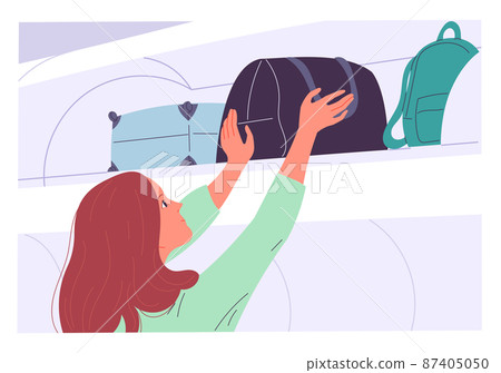 A woman pulls her bag from the top shelf after her flight 87405050