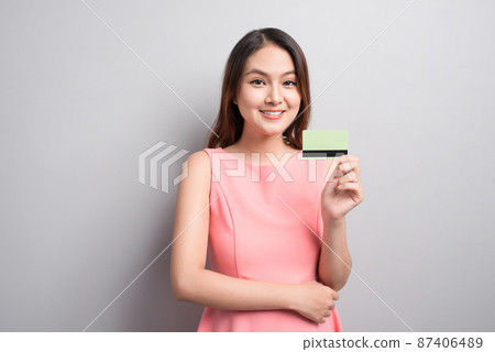 Charming asian woman hand show credit card. Presenting your product. Charming asian woman hand show credit card. Presenting your product. 87406489