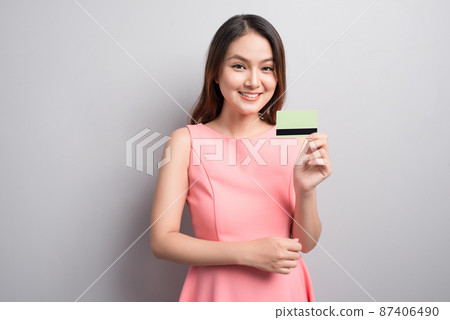 Charming asian woman hand show credit card. Presenting your product. 87406490