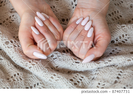 Model woman showing light pale pink nude shellac manicure on lo 87407731