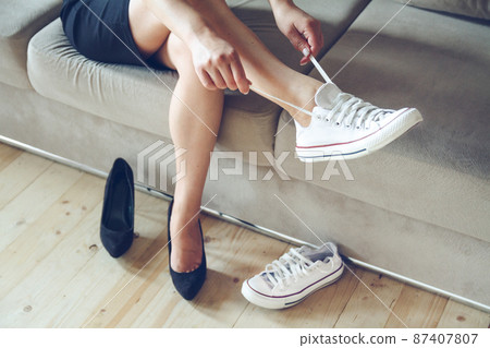 woman makes the choice between comfortable and uncomfortable shoes woman makes the choice between comfortable and uncomfortable shoes 87407807