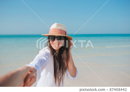 Young beautiful woman in white cotton shirt on vacation Young beautiful woman in white cotton shirt on vacation 87408442