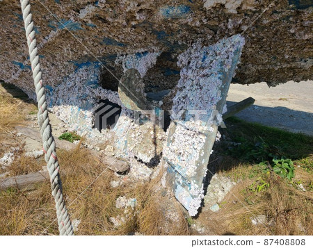 A small fishing boat with oyster shells on the bottom 87408808