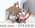 Wooden chairs and tables placed outdoors 87410636