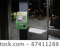 Payphone in the snow at night 87411288