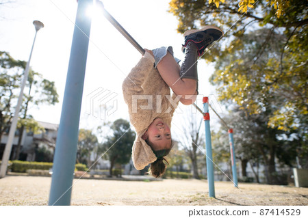 Girl playing the horizontal bar 87414529