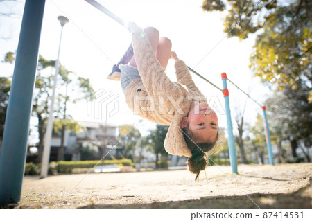 Girl playing the horizontal bar 87414531