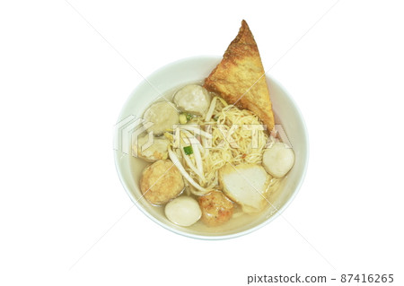 boiled Chinese yellow egg noodles topping Hakka meatball made from chop pork stuffing fried tofu with bean sprout in soup on bowl 87416265