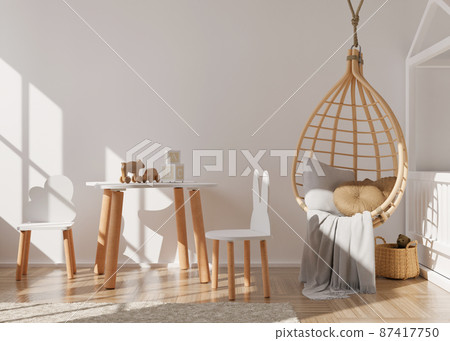 Empty white wall in modern child room. Mock up interior in scandinavian, boho style. Free, copy space for your picture, poster. Table, rattan hanging armchair, toys. Cozy room for kids. 3D rendering. Empty white wall in modern child room. Mock up interior in scandinavian, boho style. Free, copy space for your picture, poster. Table, rattan hanging armchair, toys. Cozy room for kids. 3D rendering. 87417750