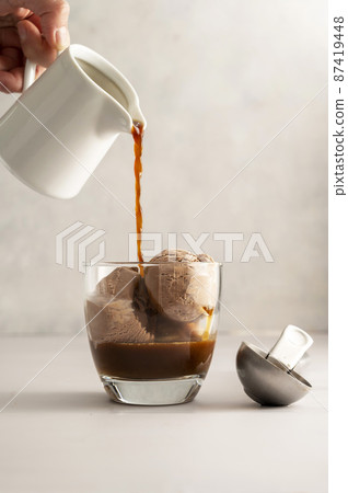 Affogato coffee, hot espresso poured over chocolate ice cream in glass on bright background Affogato coffee, hot espresso poured over chocolate ice cream in glass on bright background 87419448