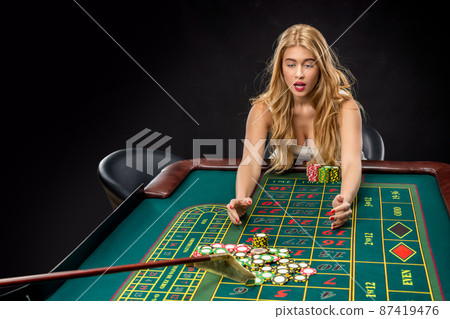 Young pretty women playing roulette wins at the casino Young pretty women playing roulette wins at the casino 87419476