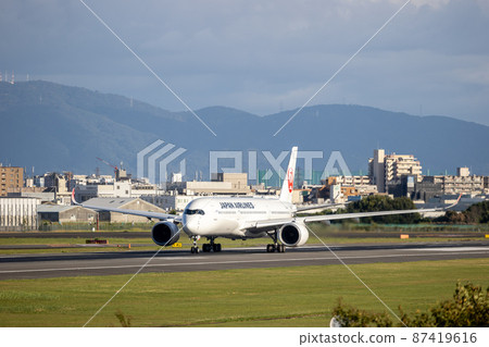 Passenger plane taking off from Osaka Airport, Japan Airlines, A350 Passenger plane taking off from Osaka Airport, Japan Airlines, A350 87419616