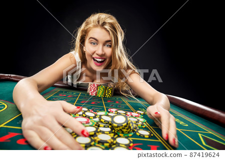 Young pretty women playing roulette wins at the casino Young pretty women playing roulette wins at the casino 87419624