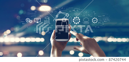 Smart industry concept with person using smartphone Smart industry concept with person using smartphone 87420744