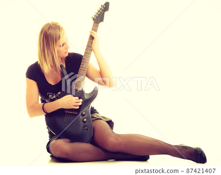 Woman artist player with electric guitar. Woman artist player with electric guitar. 87421407
