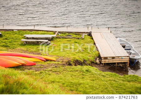 Many canoes on norwegian fjord shore Many canoes on norwegian fjord shore 87421763