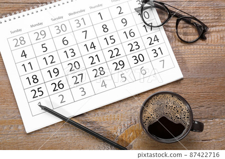 Flat lay composition with calendar and cup of coffee on wooden table 87422716