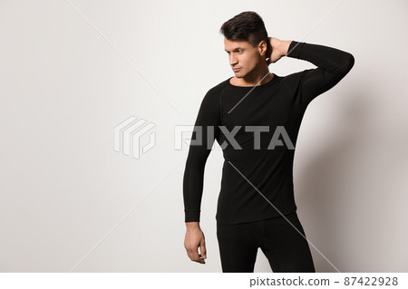 Man wearing thermal underwear on light grey background. Space for text Man wearing thermal underwear on light grey background. Space for text 87422928