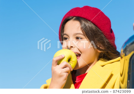 Healthy snack for a kid. Cute child eating healthy fruit Healthy snack for a kid. Cute child eating healthy fruit 87423099