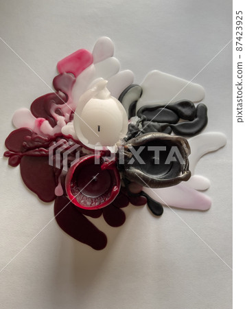 top view of several molten candles of different colors, background white, wax spread in different directions, black, white and burgundy color top view of several molten candles of different colors, background white, wax spread in different directions, black, white and burgundy color 87423925