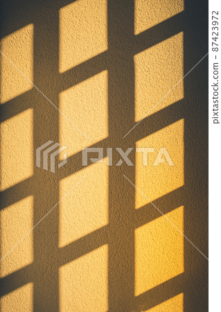 Abstract window shadows on the yellow wall. Abstract window shadows on the yellow wall. 87423972