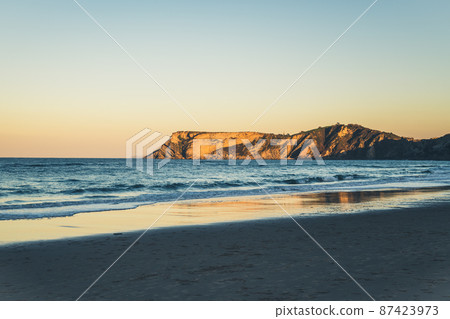 Beautiful seaside of ocean and crag at sunset, Cantabria, Spain. Beautiful seaside of ocean and crag at sunset, Cantabria, Spain. 87423973