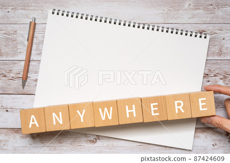 Building blocks, notebooks, pens, human hands with "ANY WHERE" written on them 87424609