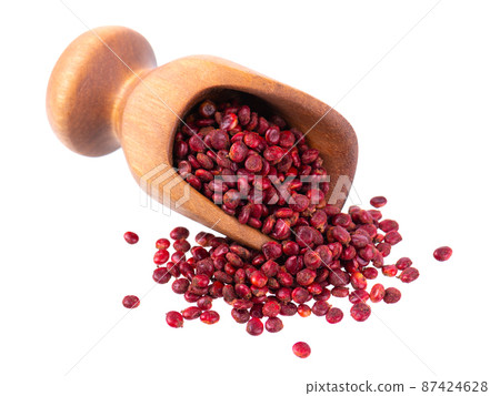 Sumac seeds in wooden scoop, isolated on white background. Whole dry Rhus berry. 87424628
