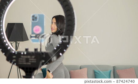 Virtual online fitness. Woman virtual workout at home living room Virtual online fitness. Woman virtual workout at home living room 87424740