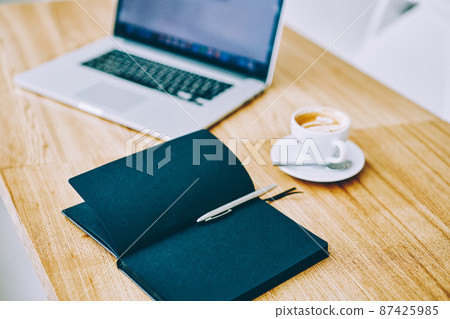 Notebook with cup of coffee and netbook on table Notebook with cup of coffee and netbook on table 87425985