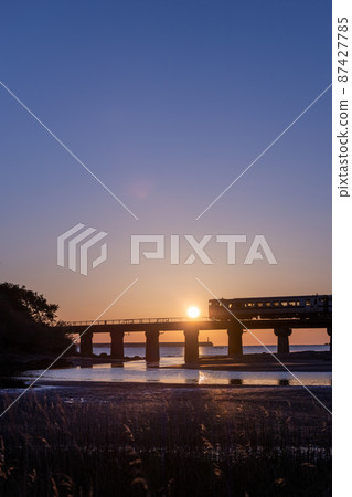 JR Kyushu Kiha 40 Nichinan Line commuter train running on Nichinan Coast Sannohama in Sanno, Nichinan City, Miyazaki Prefecture, rising with magic hour 87427785
