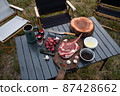 Sliced grilled thai steak served on white plate with grilled sliced lemon, tomatoes, garlic 87428662