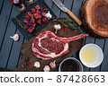 Sliced grilled thai steak served on white plate with grilled sliced lemon, tomatoes, garlic 87428663