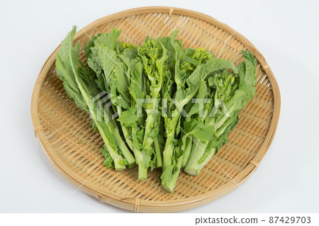 Rape blossoms on a colander 87429703