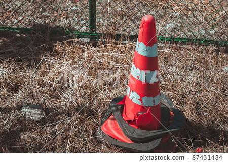 Tattered traffic cone Tattered traffic cone 87431484