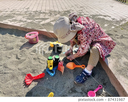Children playing in the sandbox 87431987