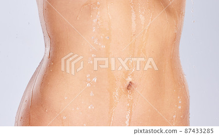 Pamper yourself a little. Studio shot of an unrecognisable woman taking a shower against a grey background. 87433285