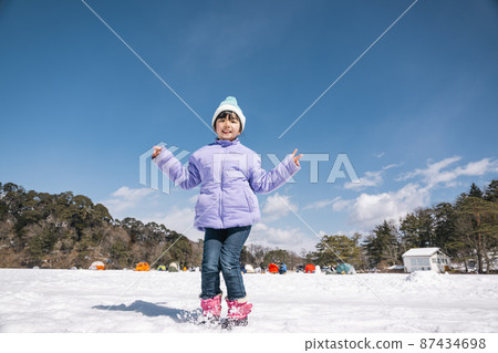 A girl jumping on the slopes 87434698