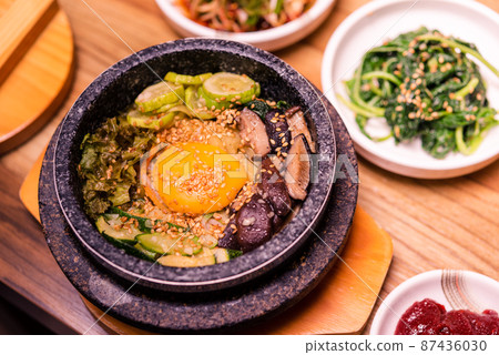 Korean traditional dish- bibimbap mixed rice with vegetables Include beef and fried egg 87436030