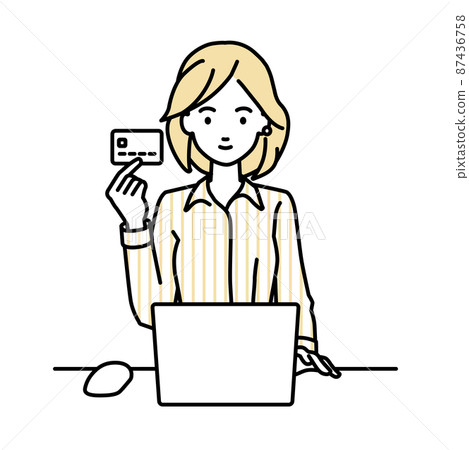 A woman in a blouse sitting at a desk and using a PC while holding a credit card 87436758